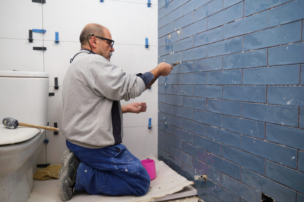 Professional installing ceramic bathroom tiles for a stylish, durable look