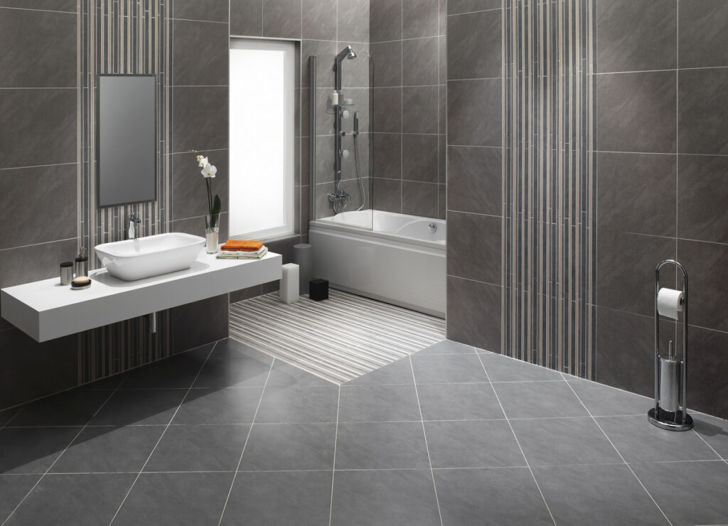 A sleek modern bathroom with elegant wall and floor tile designs
